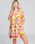 Woman wearing a colorful floral dress on a gray background
