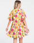 Woman wearing a colorful floral dress on a white background