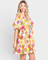 Woman wearing a colorful floral dress on a white background