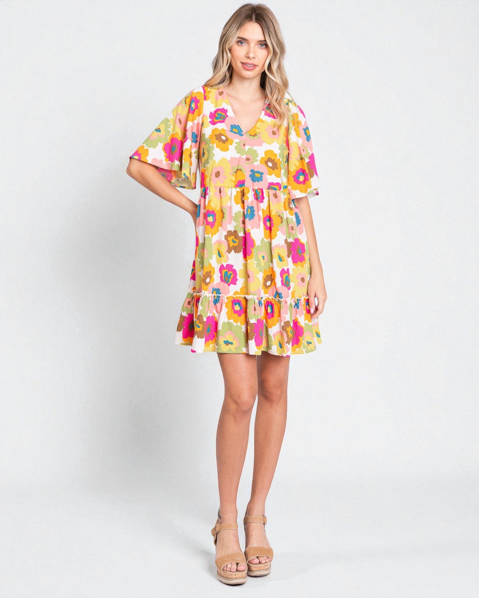 Woman wearing a colorful floral dress on a white background