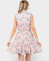 A woman shown from the back wearing a sleeveless collared fit-and-flare dress with a pink, blue, and white floral pattern, set against a solid light gray background.