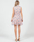 Woman wearing a sleeveless floral dress on a white background