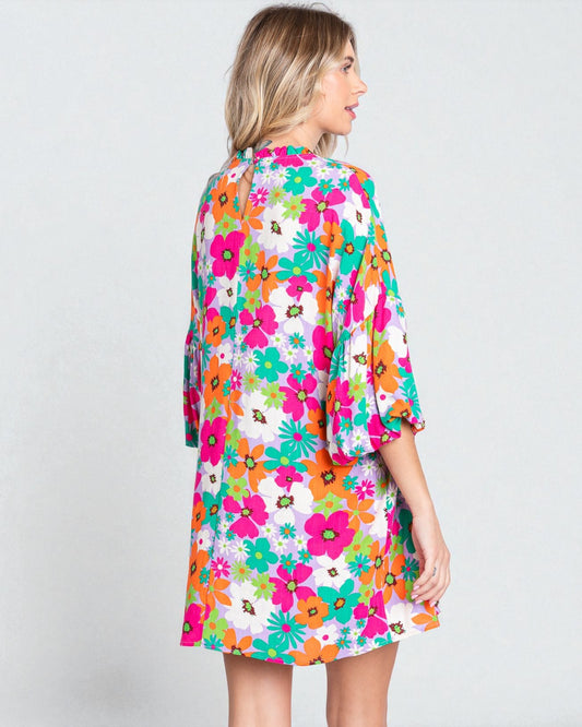 Woman wearing a colorful floral dress on a white background