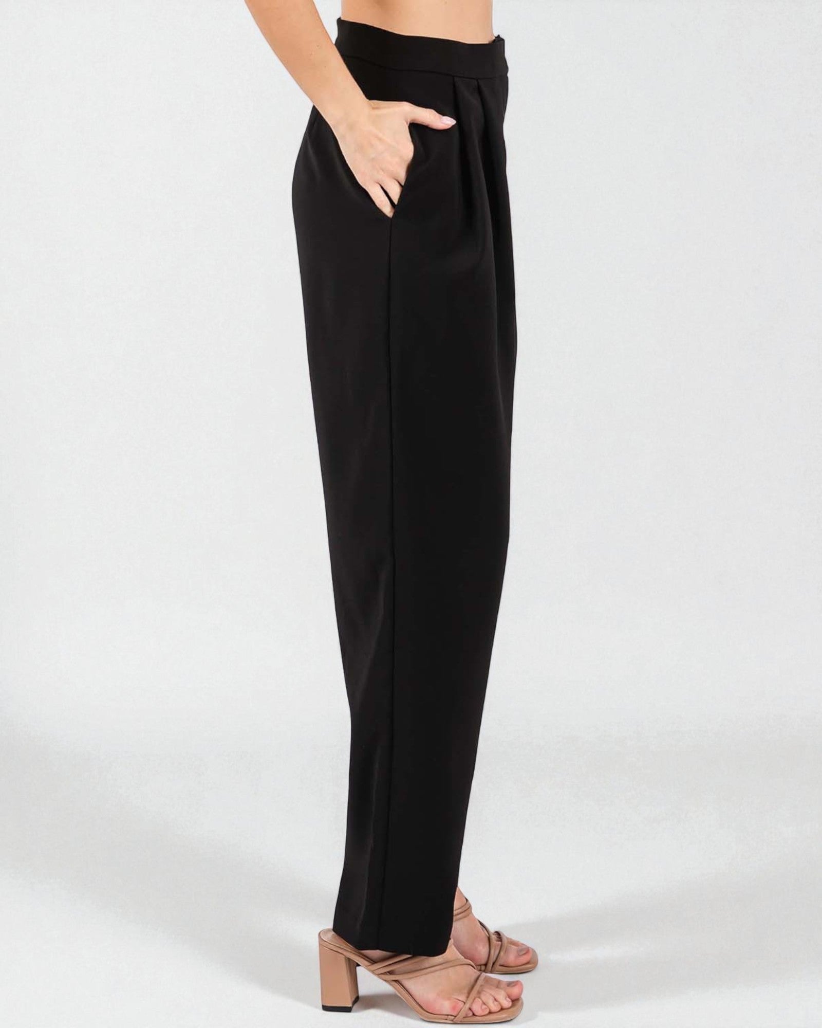 Black pants worn by a person on a white background