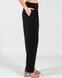 Black pants worn by a person on a white background