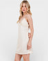 Woman wearing a white lace dress against a plain background
