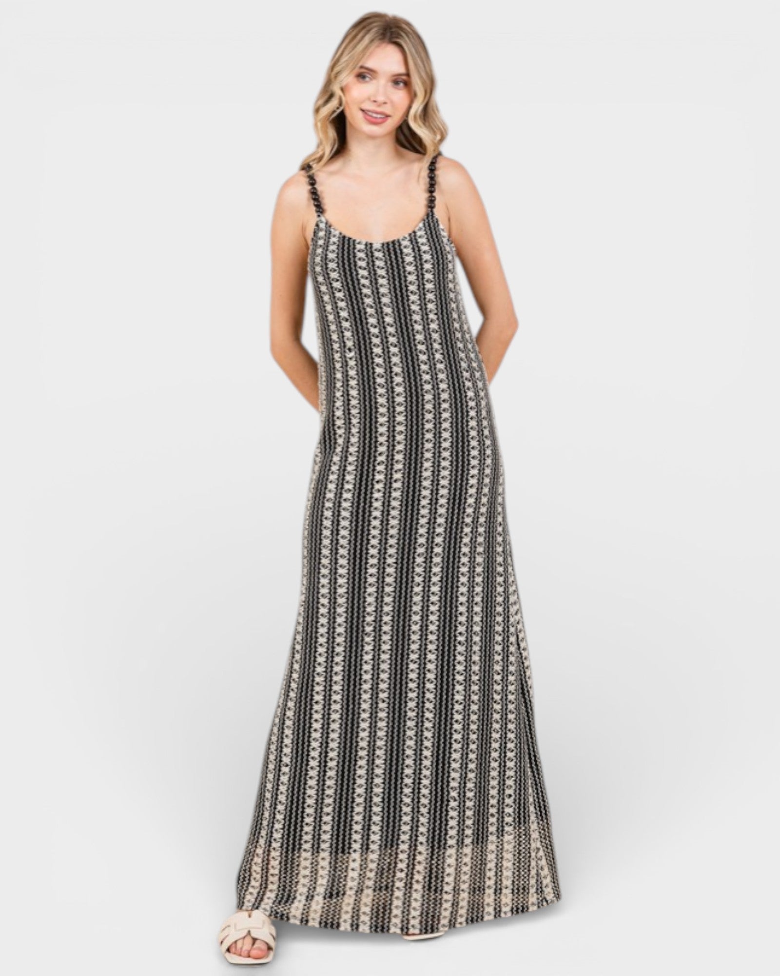 Woman wearing a black and white patterned dress on a white background