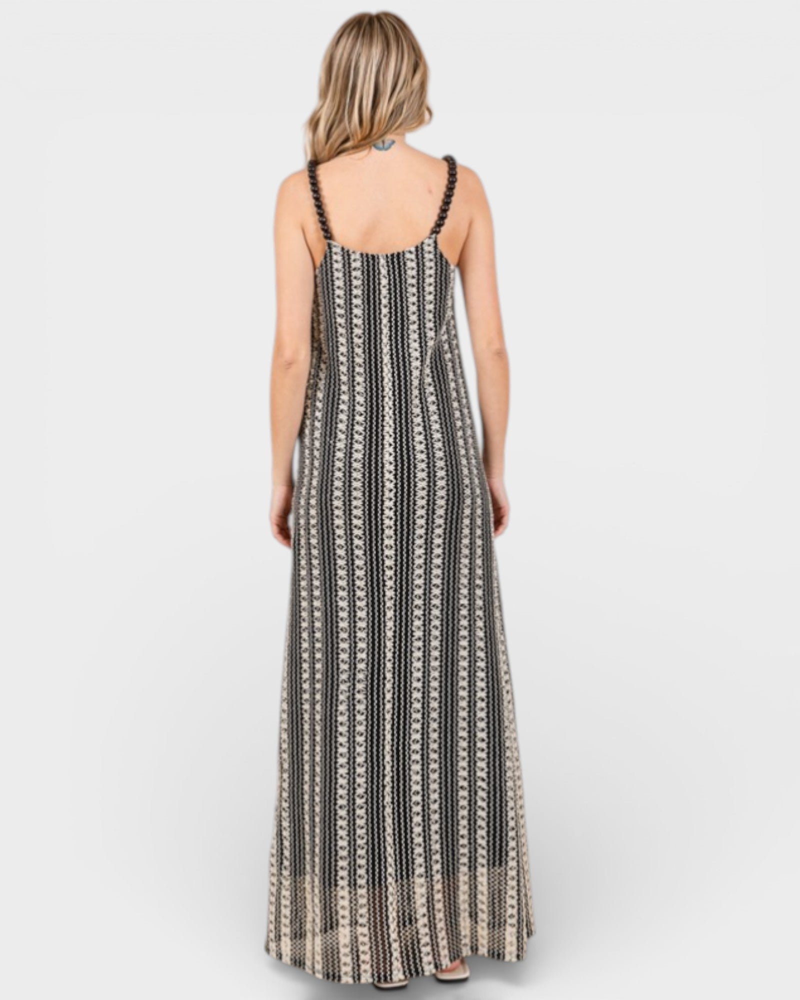 Woman wearing a black and white patterned dress on a white background