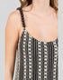 Black and white patterned dress with bead shoulder straps on a plain background