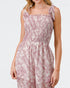Woman wearing a pink floral dress on a white background