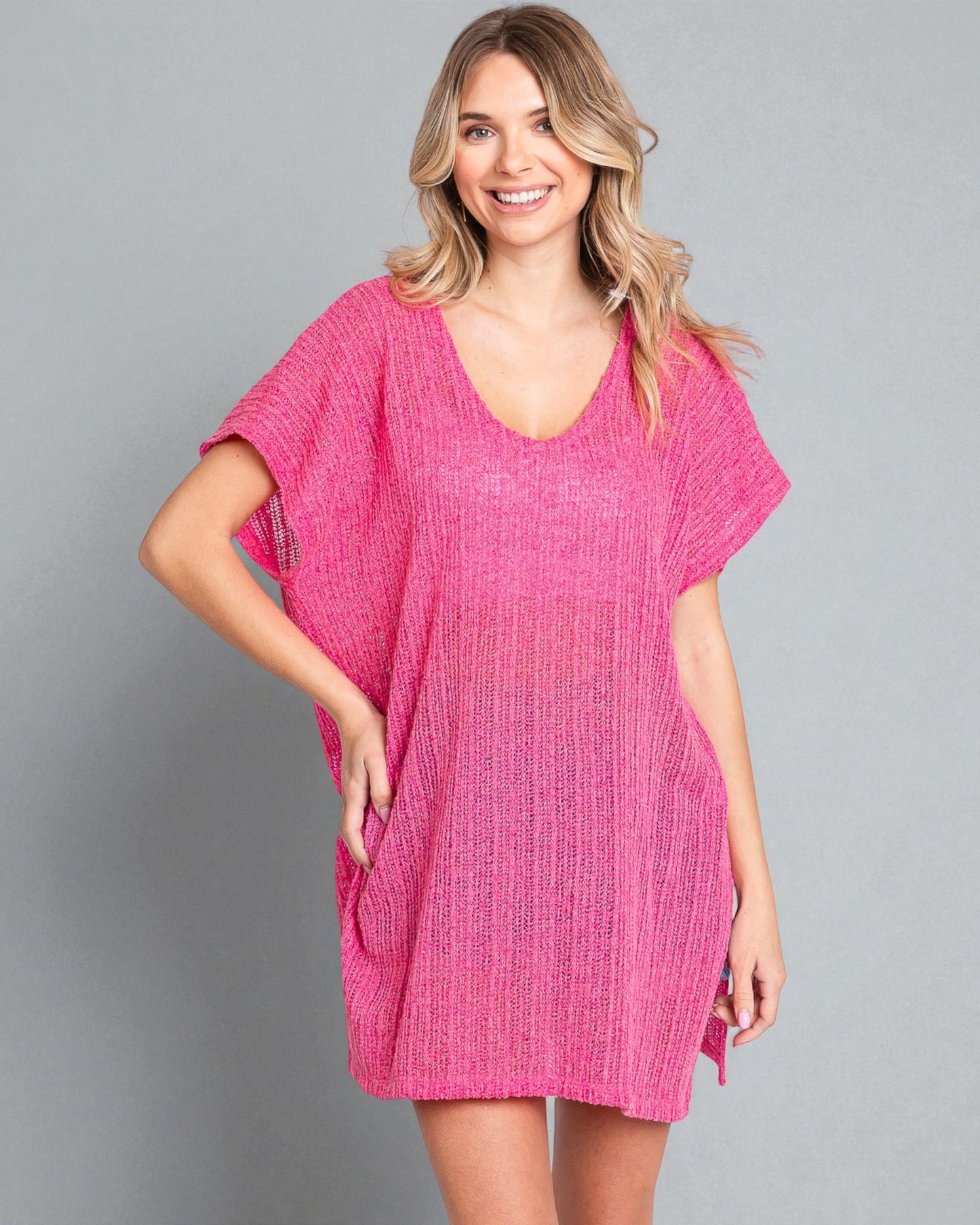 Woman wearing a pink dress against a gray background