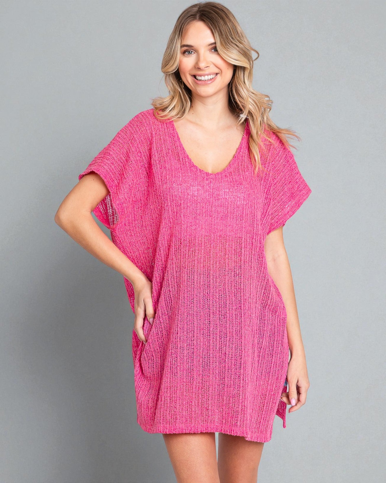 Woman wearing a pink dress against a gray background