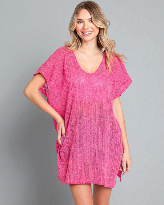 Woman wearing a pink dress against a gray background