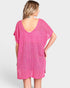Woman wearing a pink dress against a white background