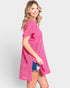 Woman wearing a pink textured dress on a white background
