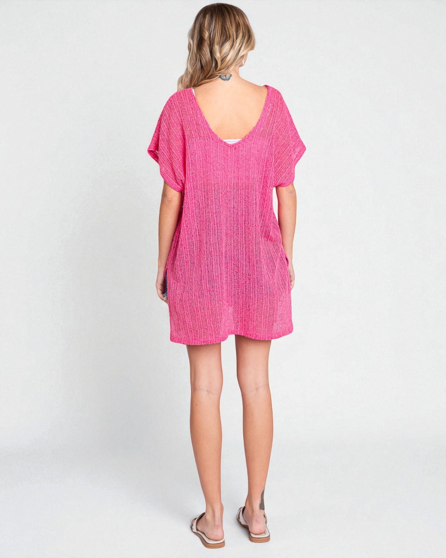 Woman wearing a pink dress on a white background