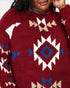 A close-up of a person wearing a fuzzy knit sweater with a Southwestern geometric pattern in burgundy, cream, and blue.