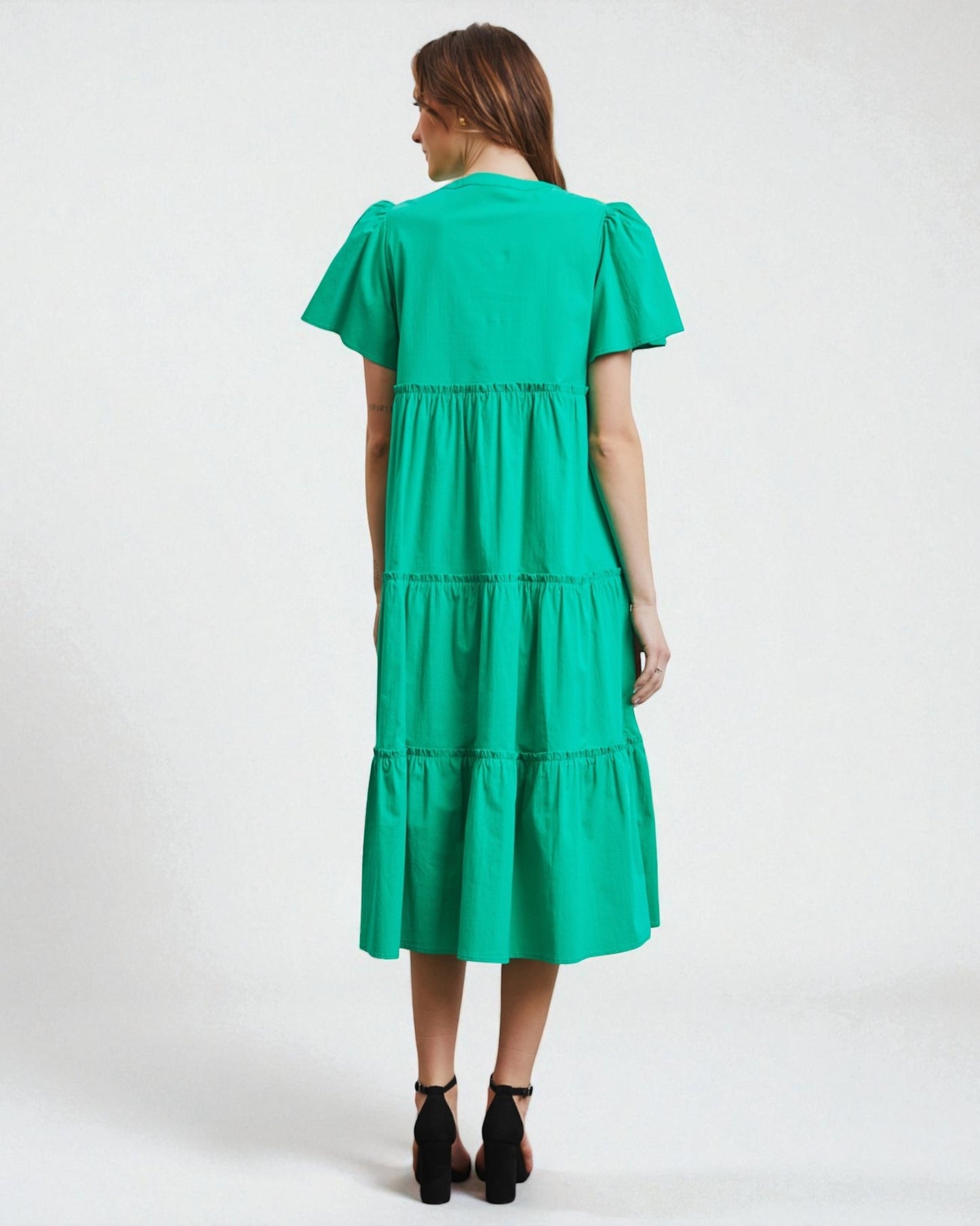 Green dress worn by a person on a white background