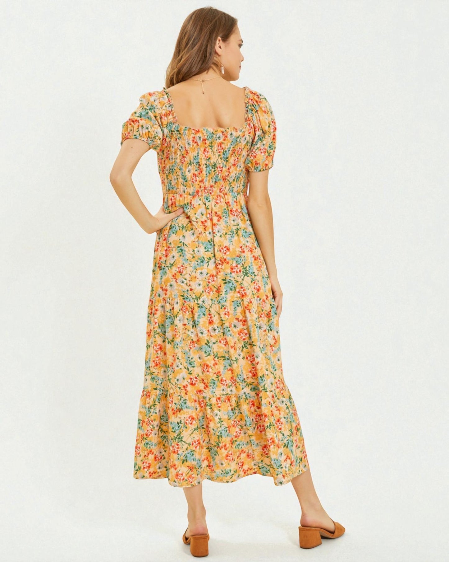 Woman wearing a floral dress on a white background