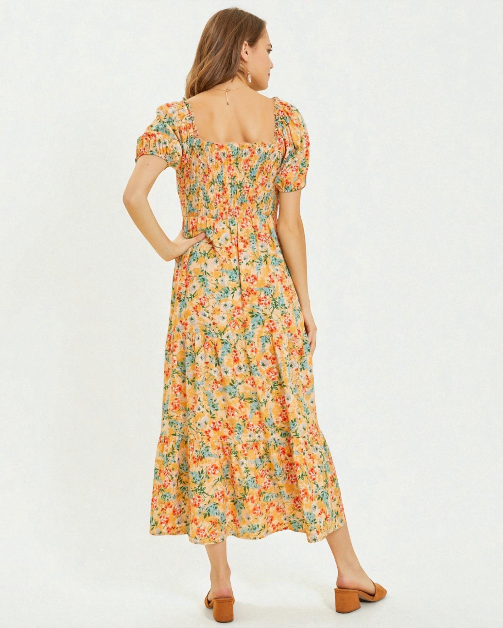 Woman wearing a floral dress on a white background