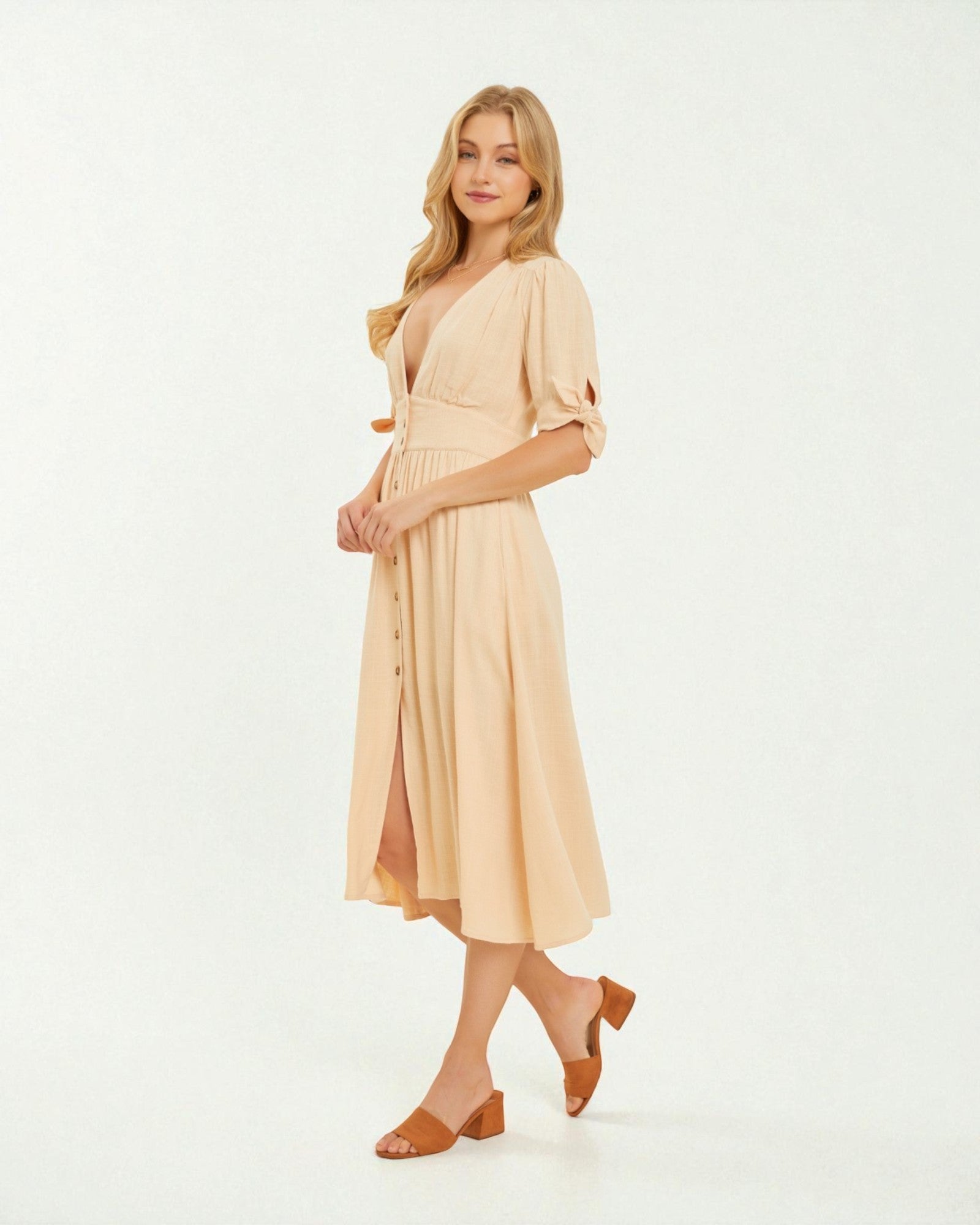 Woman wearing a beige dress on a white background