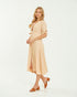 Woman wearing a beige dress on a white background