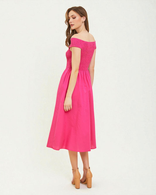 Woman wearing a pink off-shoulder dress on a white background