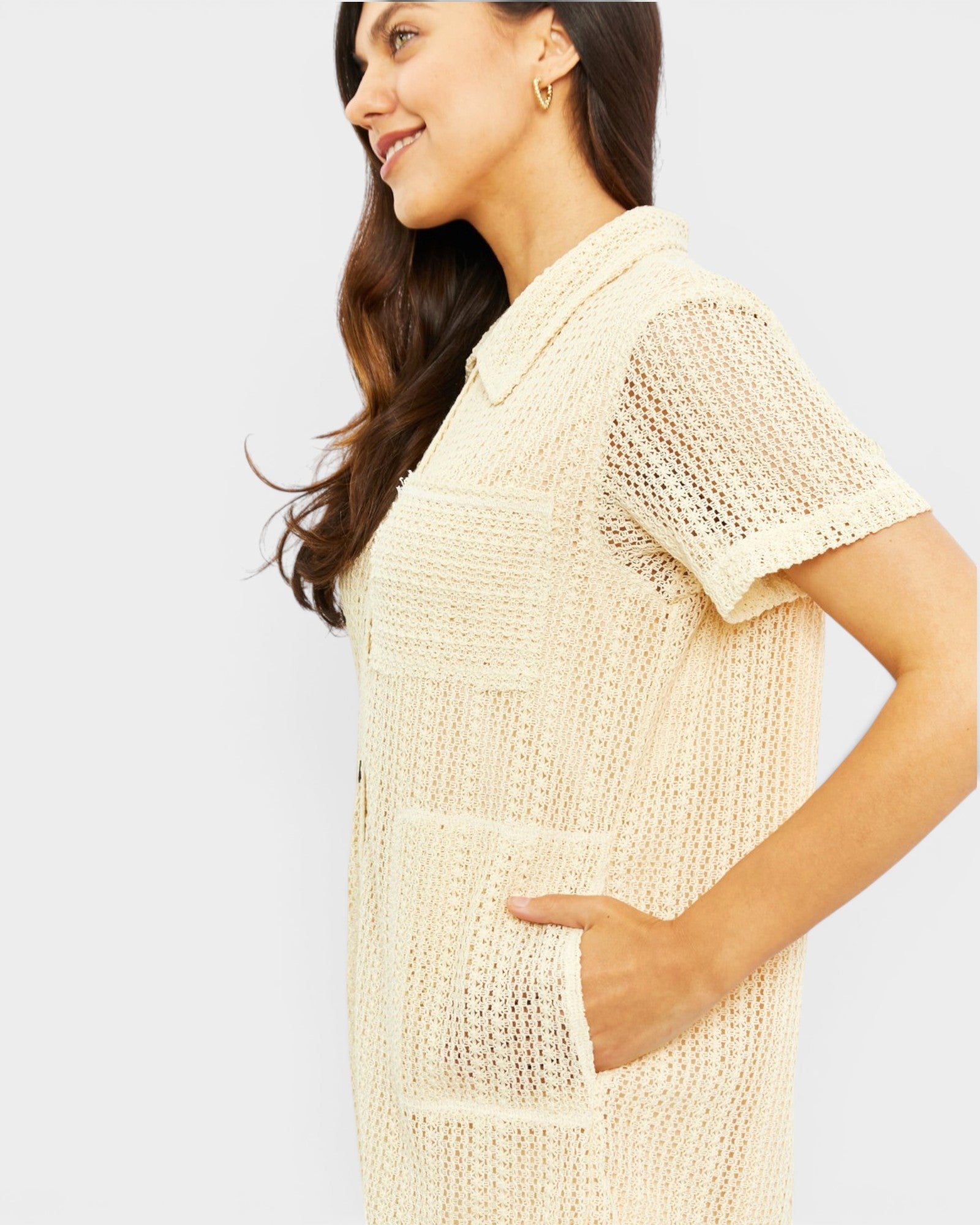Woman wearing a beige textured romper on a white background