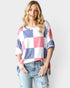 Camiseta de manga corta con cuello redondo y cuadros rojos, blancos y azules