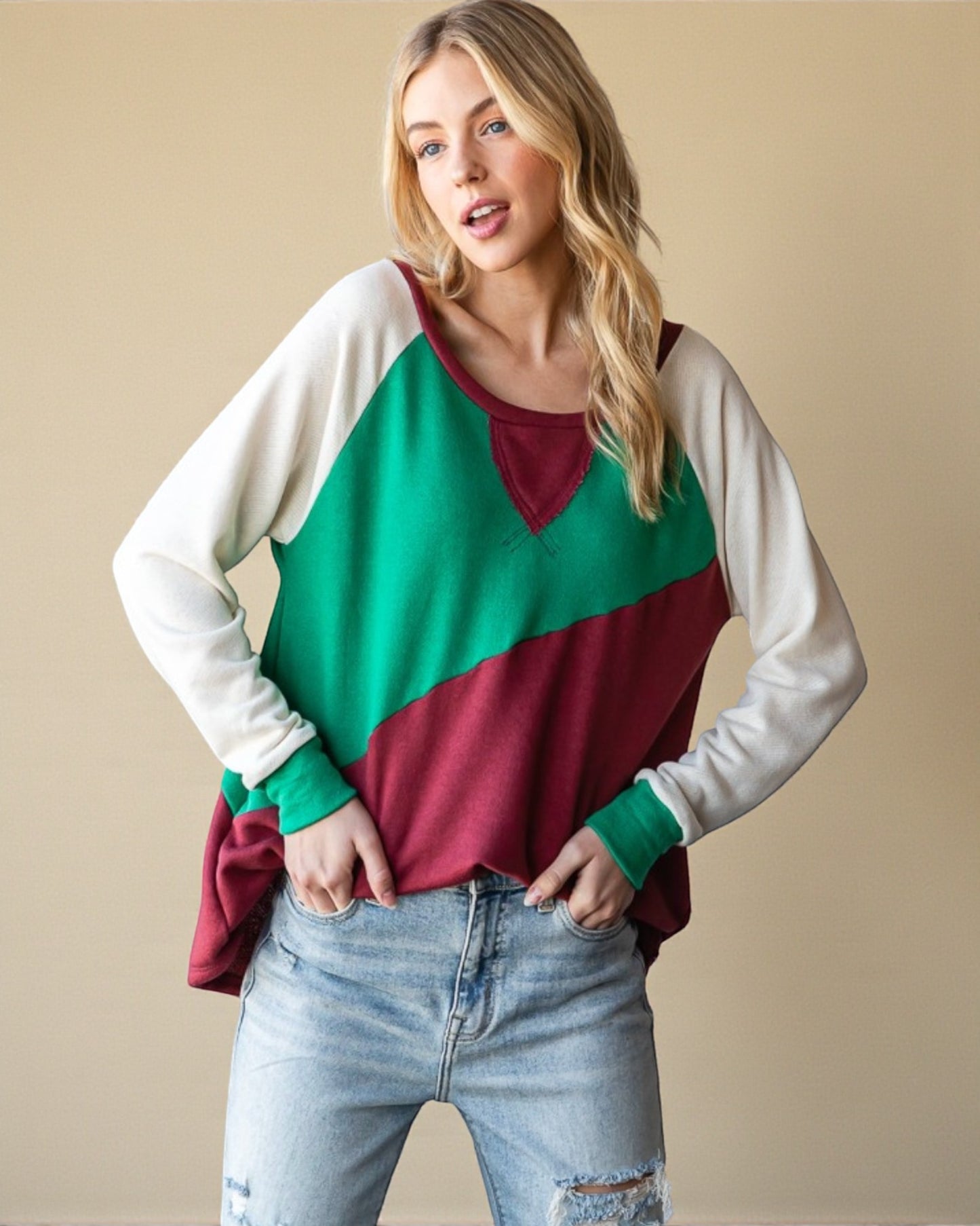 Woman wearing a colorful sweater with a beige background