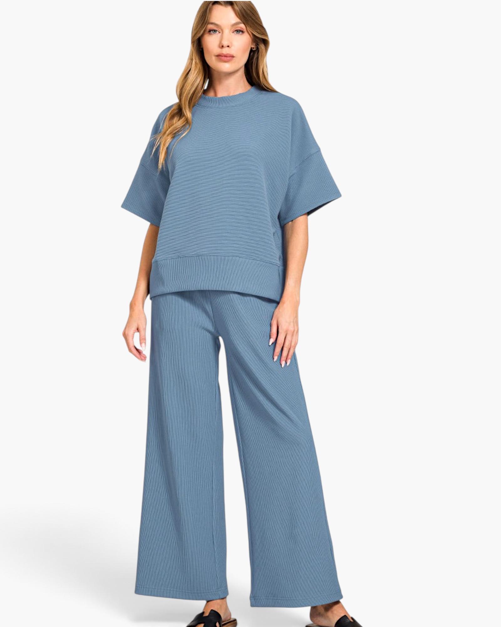 Model wearing a Beach Rose Co. dusty blue ribbed two-piece set with a round neck tee and wide-leg pants.