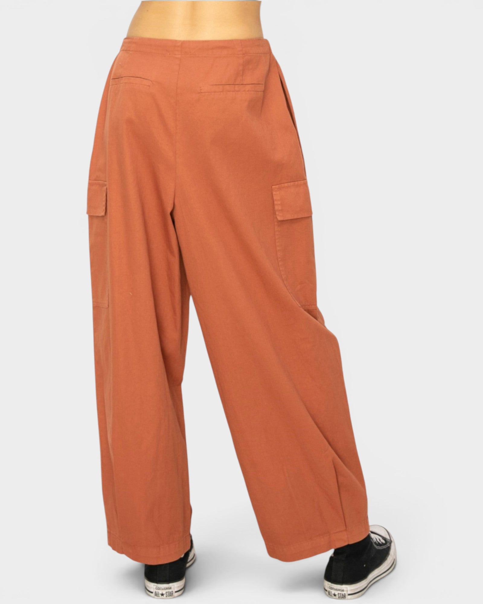 Orange cargo pants on a white background