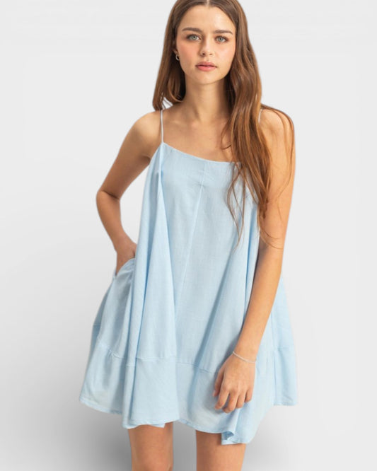 Woman wearing a light blue dress on a white background