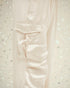 Close-up of a light pink shirt with a pocket on a textured white background