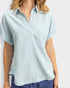 Light blue short-sleeve shirt worn by a person on a white background