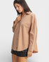 Woman wearing a beige shirt on a white background