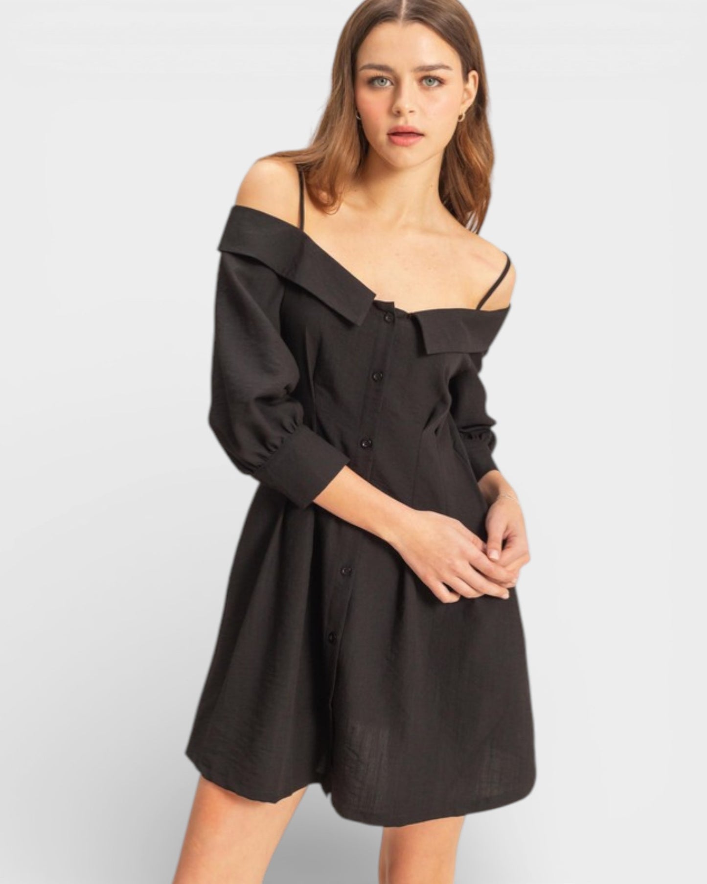 Woman wearing a black off-shoulder dress on a white background