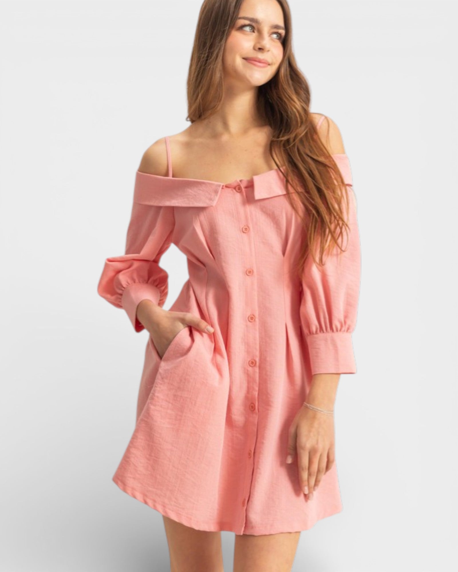Woman wearing a pink off-shoulder dress on a white background