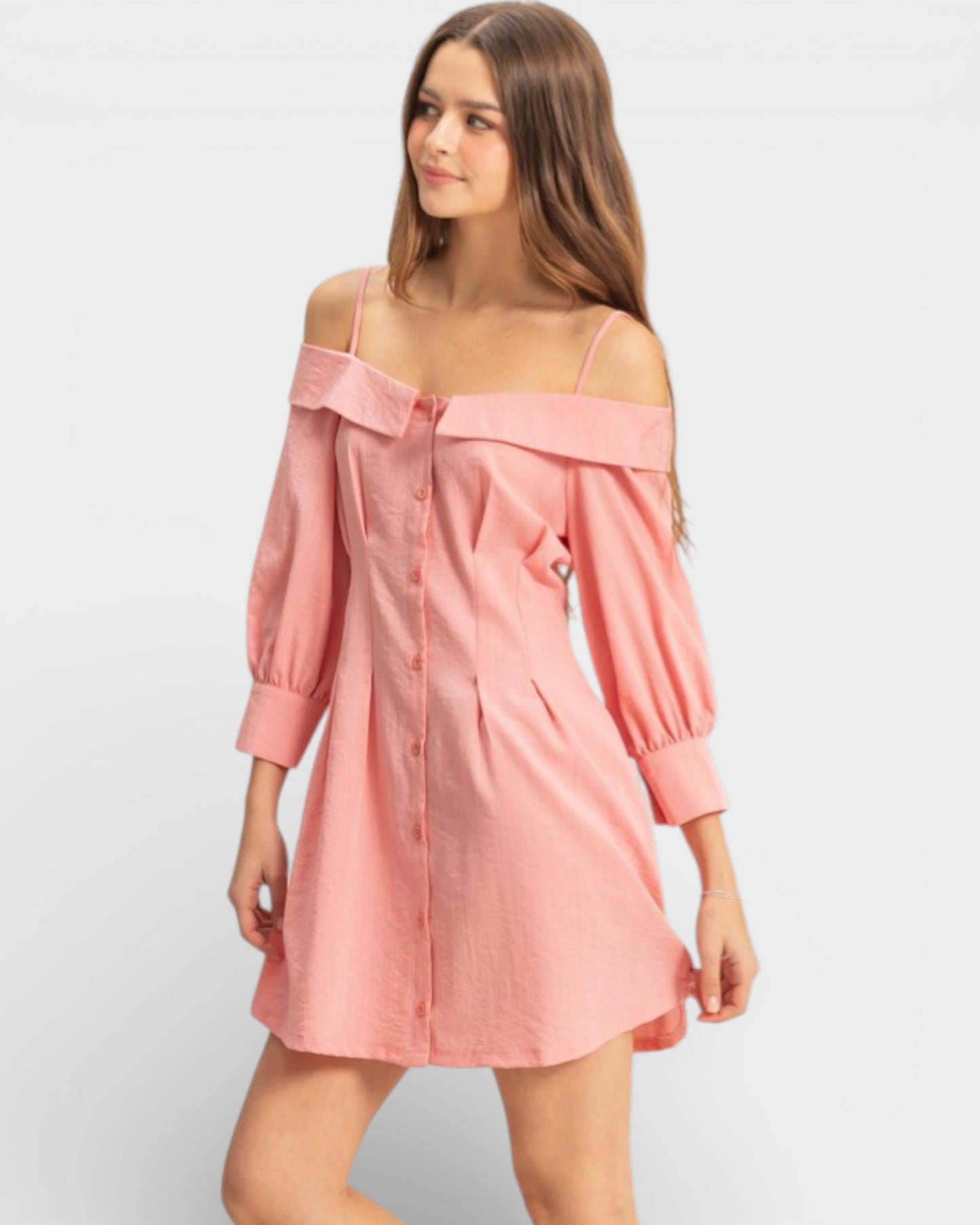 Woman wearing a pink off-shoulder dress on a white background