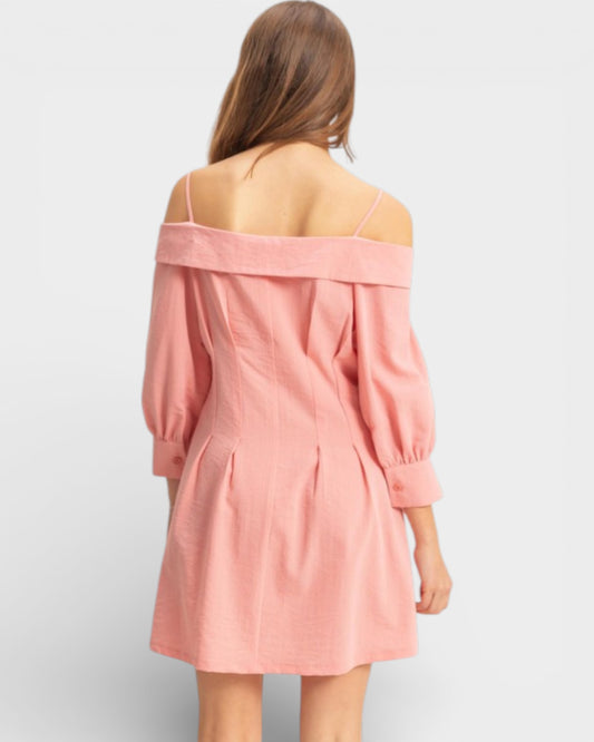 Pink off-shoulder dress worn by a person on a light gray background