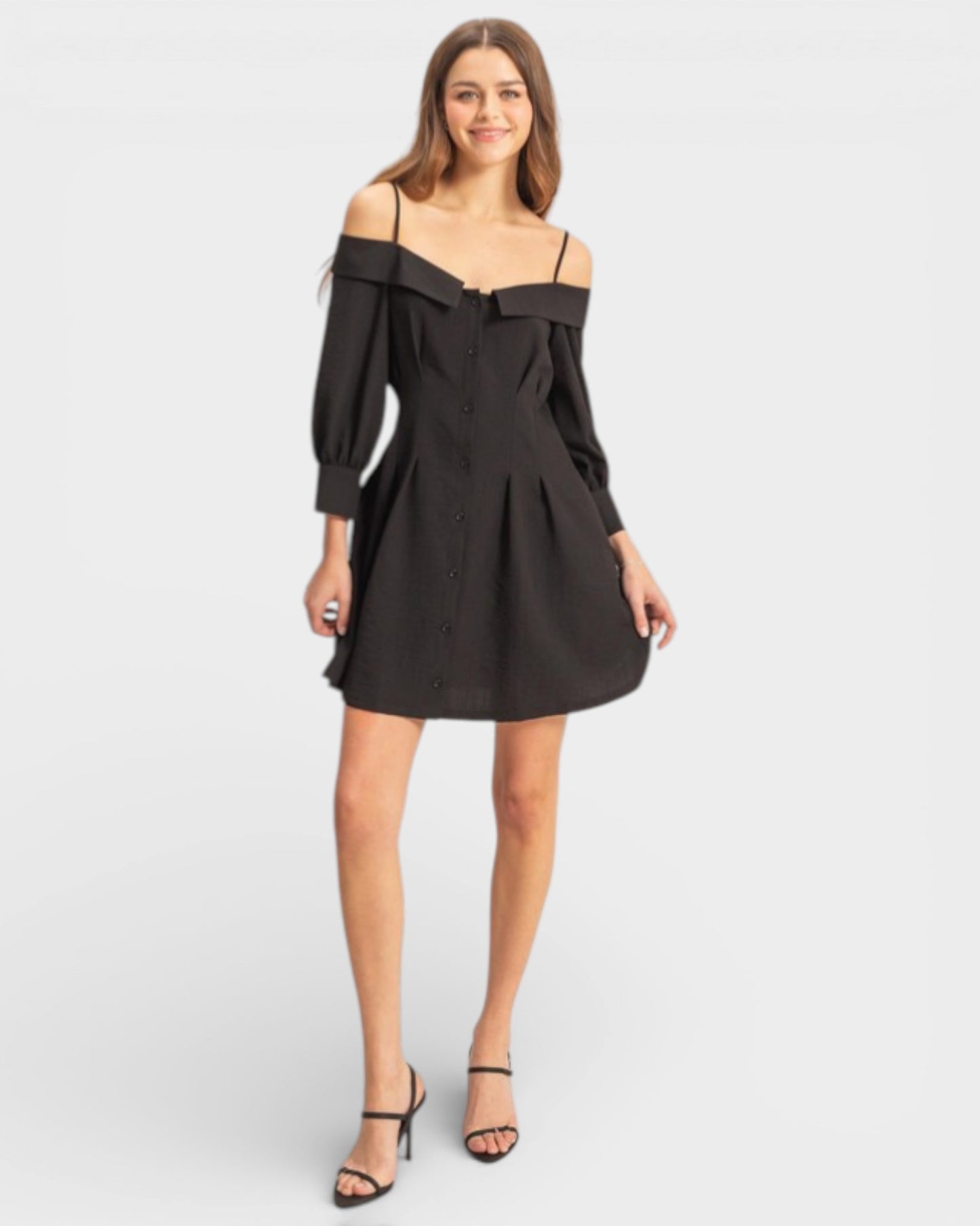 Woman wearing a black off-shoulder dress on a white background