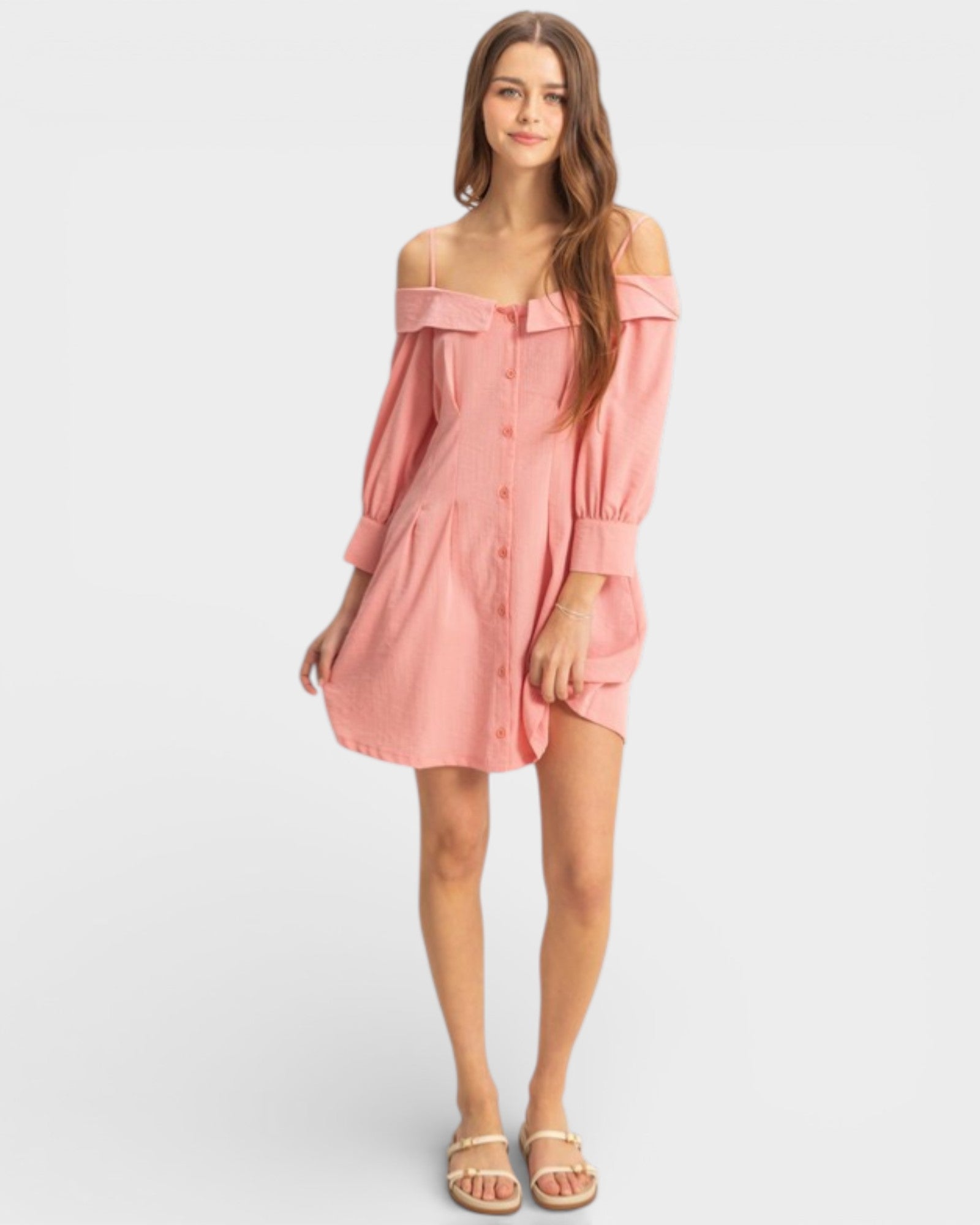 Woman wearing a pink off-shoulder dress on a white background