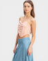 Woman wearing a strapless pink top and denim skirt on a white background