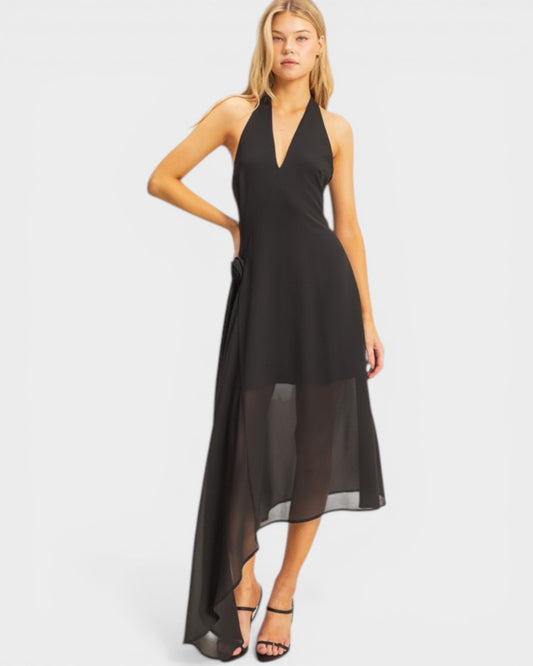 Woman wearing a black halter neck dress on a white background