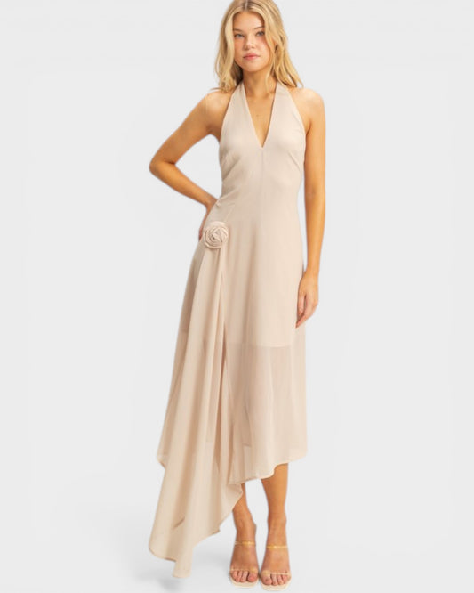 Woman wearing a beige halter neck dress on a white background