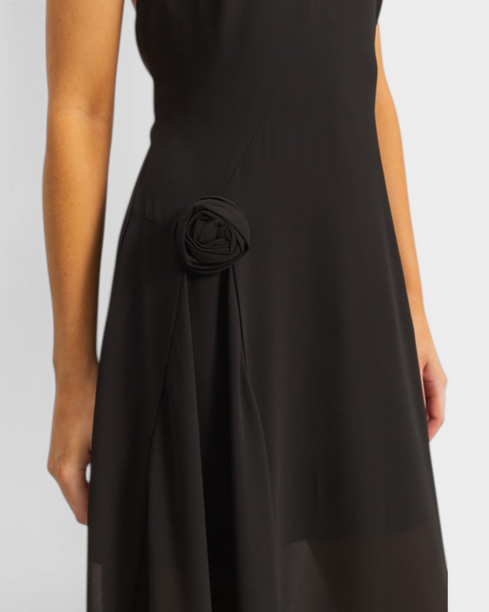 Black dress with a floral detail on a white background