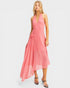 Woman wearing a pink halter neck dress on a white background