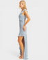 Woman wearing a light blue dress with a slit on a white background