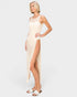 Woman wearing a beige crochet dress on a white background