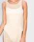 Beige sleeveless crochet dress worn by a person on a plain background